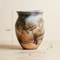 A small handcrafted ceramic vase with a rounded body, flared rim, and earthy marbled pattern in brown, beige, gray, and black. Measurement annotations show the height as 6.