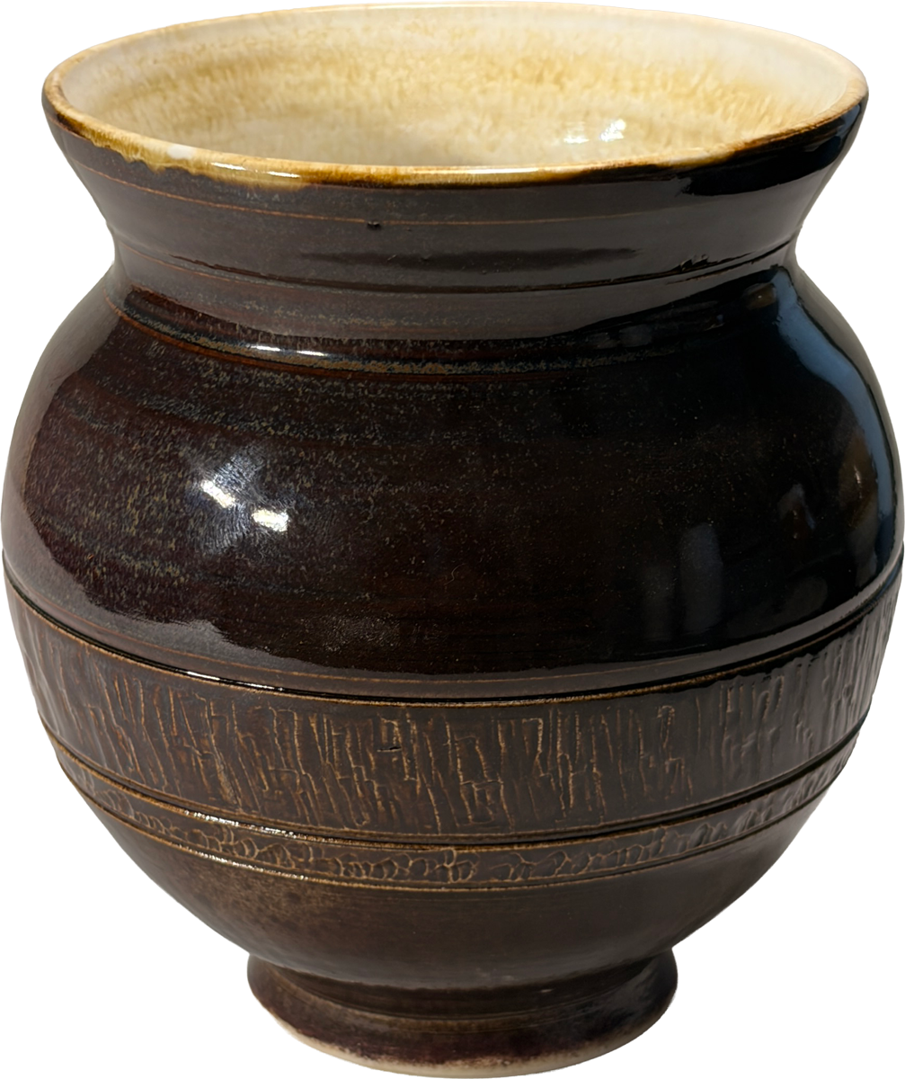 A dark brown glazed ceramic vase with a flared rim, featuring a textured band around the middle and a warm cream-colored interior glaze.